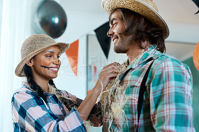 Buy stock photo Shot of a young couple getting dressed for halloween at home