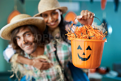 Buy stock photo Shot of a young couple dressed in halloween costumes being being playful at home