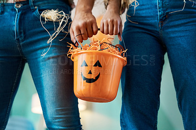 Buy stock photo Shot of two unrecognizable people holding a bucket at home