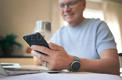 Buy stock photo Shot of a mature man enjoying a cup of coffee while using his smartphone