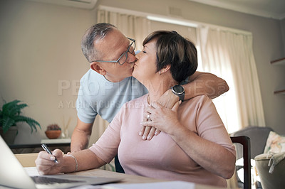 Buy stock photo Shot of a mature husband affectionately kissing his wife