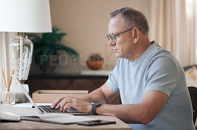 Buy stock photo Shot of a mature man typing on his laptop
