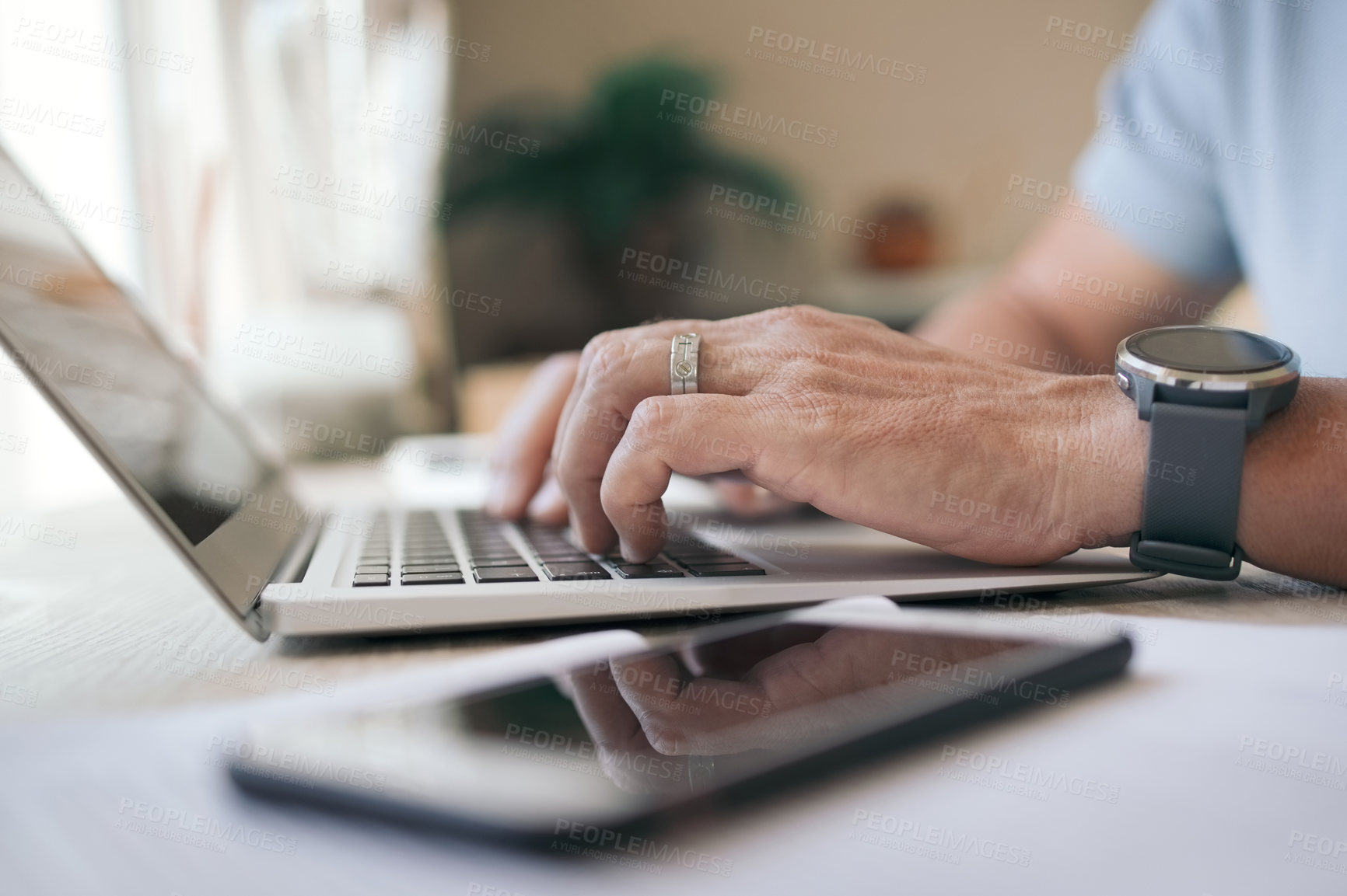 Buy stock photo Shot a man working from home using his laptop