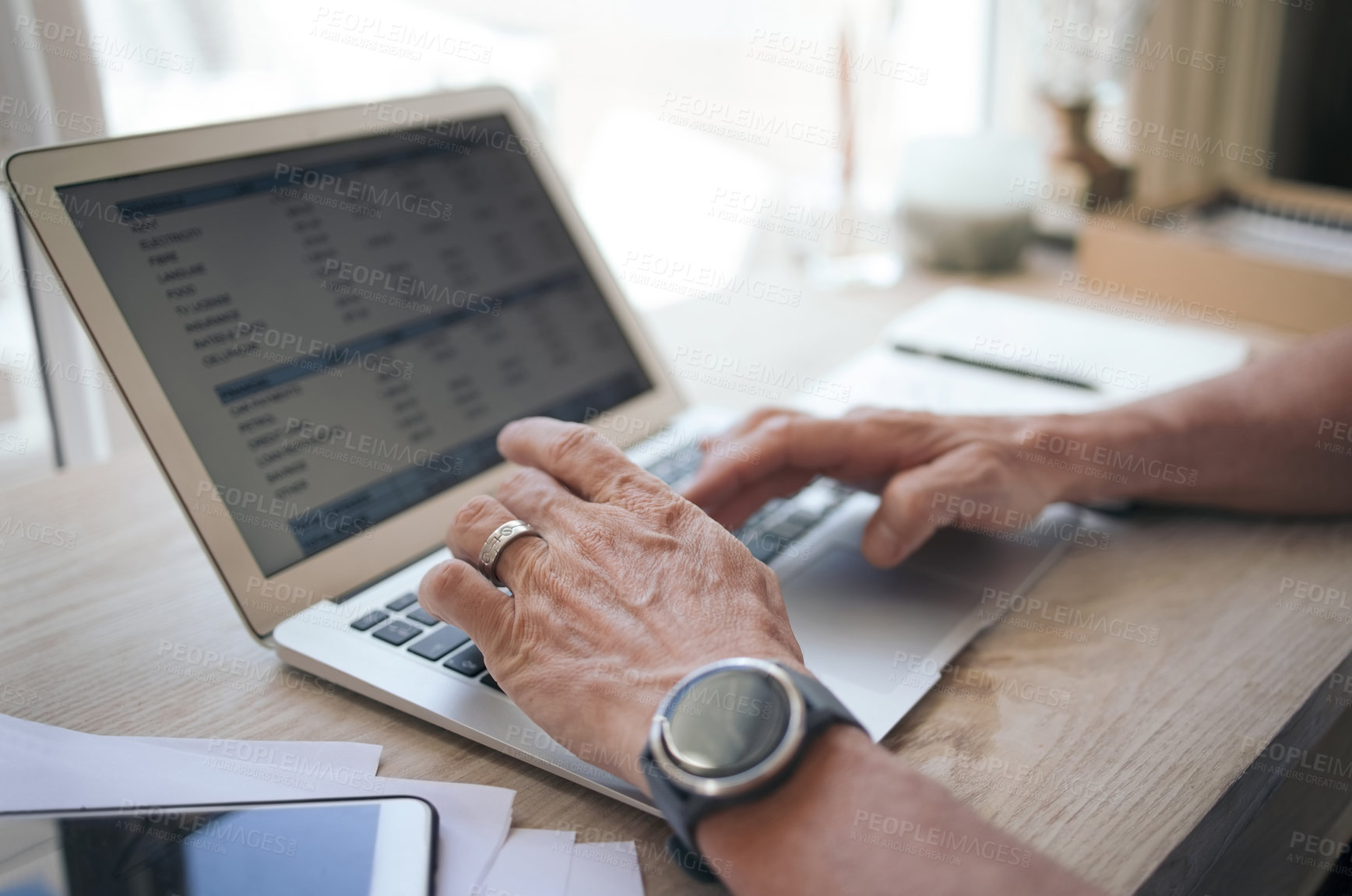 Buy stock photo Shot a man working from home using his laptop