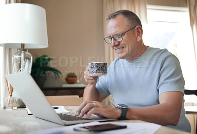 Buy stock photo Shot of a mature man drinking a cup of coffee while working