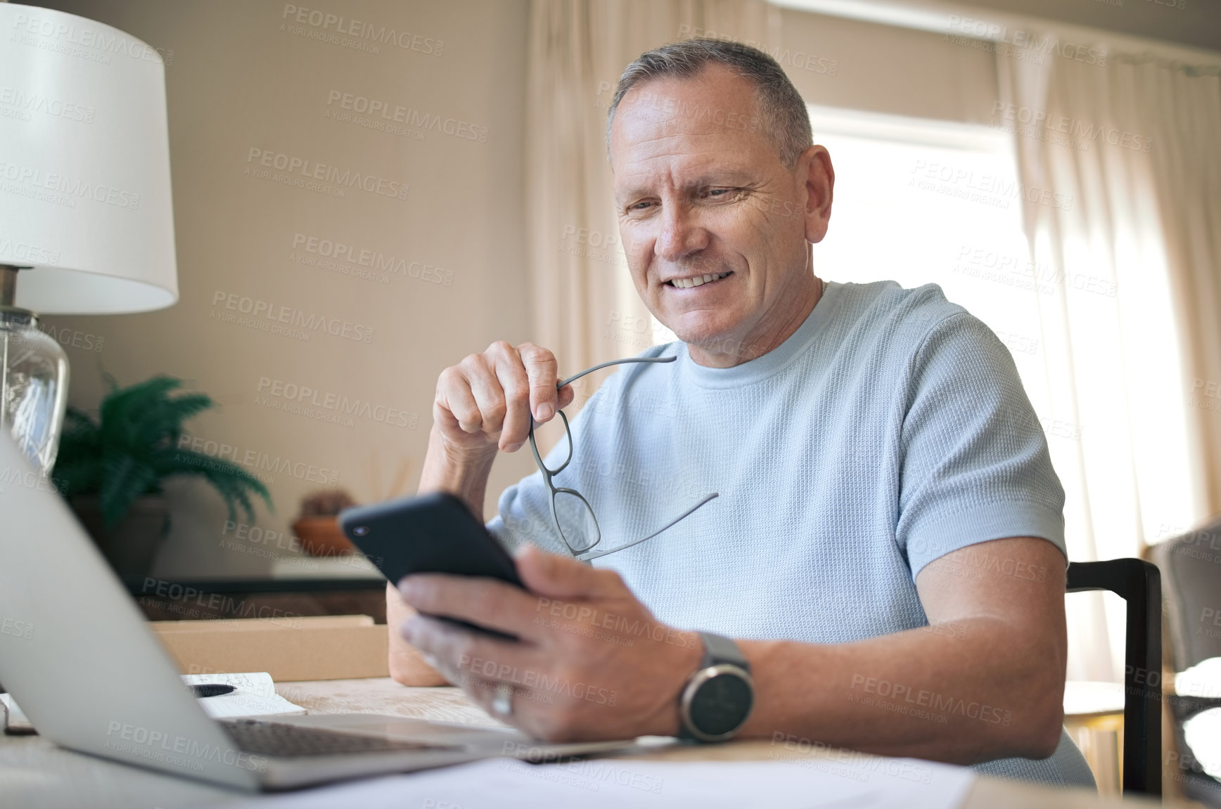 Buy stock photo Shot of a mature man using his smartphone to send messages