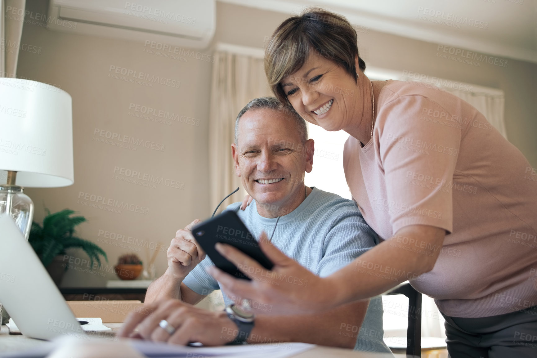 Buy stock photo Shot of a husband and wife taking a selfie together
