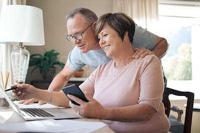 Buy stock photo Shot of a mature husband and wife using a laptop together