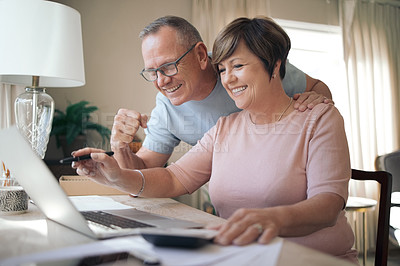Buy stock photo Shot of a mature husband and wife using a laptop together