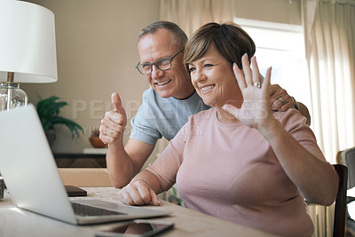 Buy stock photo Shot of a mature husband and wife using their laptop to make a video call