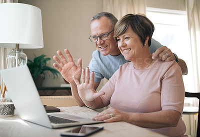 Buy stock photo Shot of a mature husband and wife using their laptop to make a video call