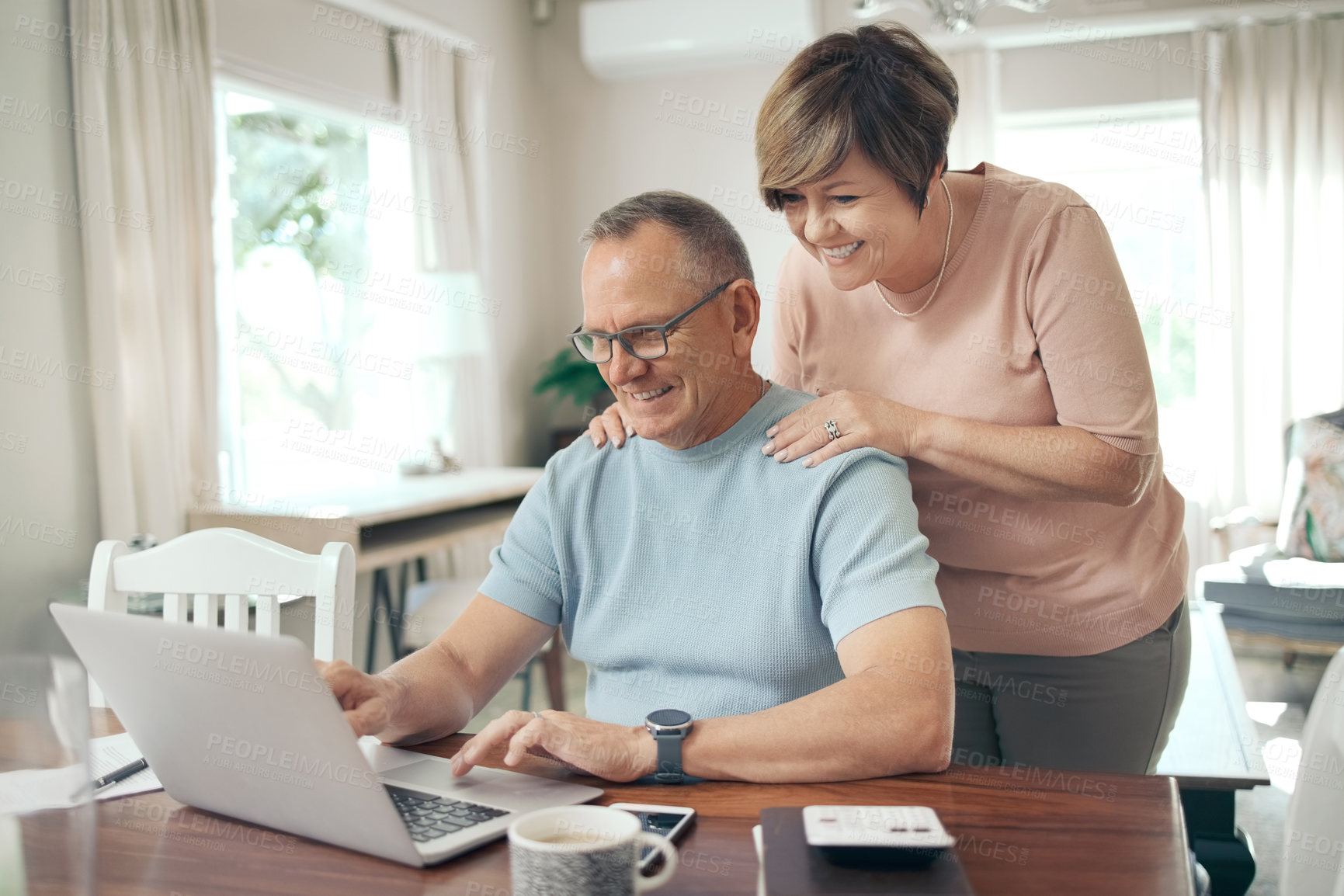 Buy stock photo Shot of a mature husband and wife using a laptop together