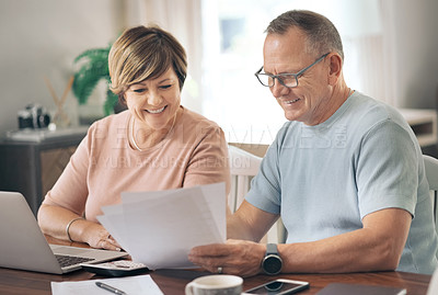 Buy stock photo Shot of a mature husband and wife going over home insurance documents together