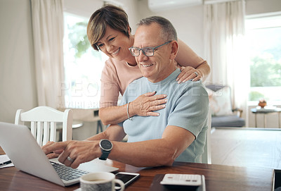 Buy stock photo Shot of a mature husband and wife using a laptop together