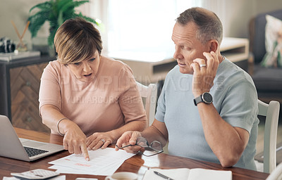 Buy stock photo Shot of a mature husband and wife going over their finances together