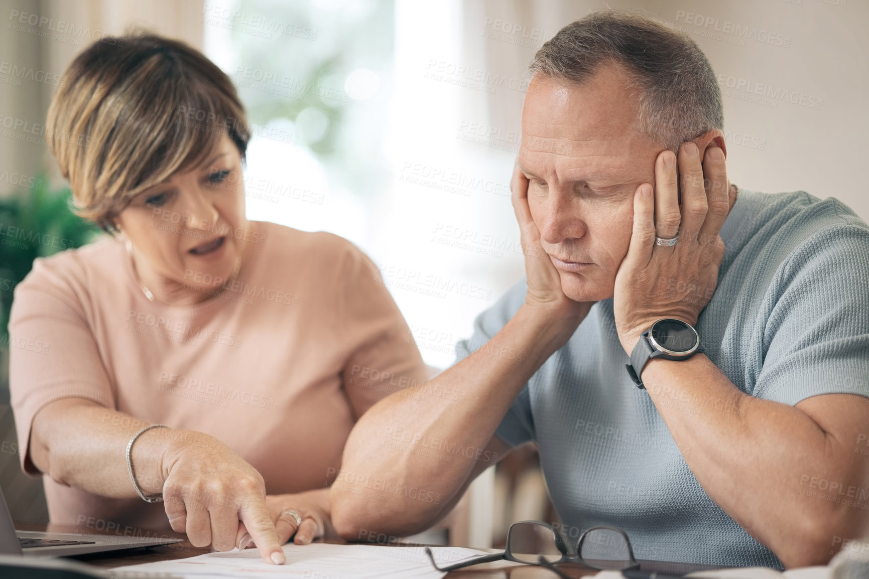 Buy stock photo Shot of a mature husband and wife going over their finances together