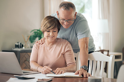 Buy stock photo Shot of a mature husband and wife going over their finances together