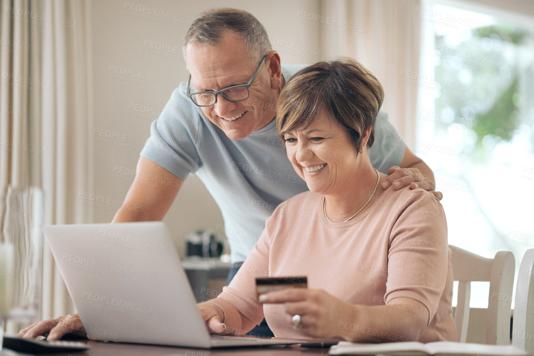 Buy stock photo Shot of a mature woman using her card to make online payments