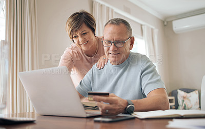 Buy stock photo Shot of a mature man using his bank card to make online payments