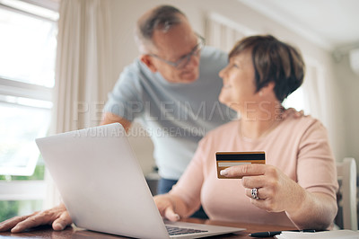 Buy stock photo Shot of a mature woman using her card to make online payments