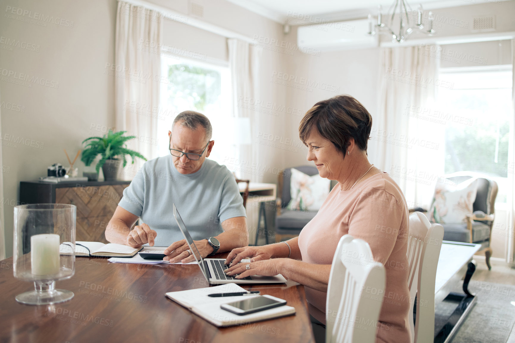 Buy stock photo Shot of a mature couple calculating their budget together