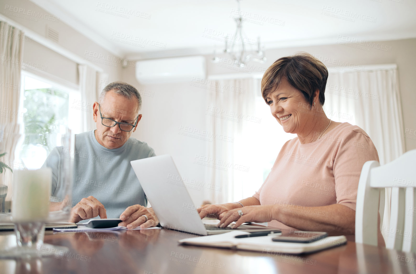 Buy stock photo Shot of a mature couple calculating their budget together