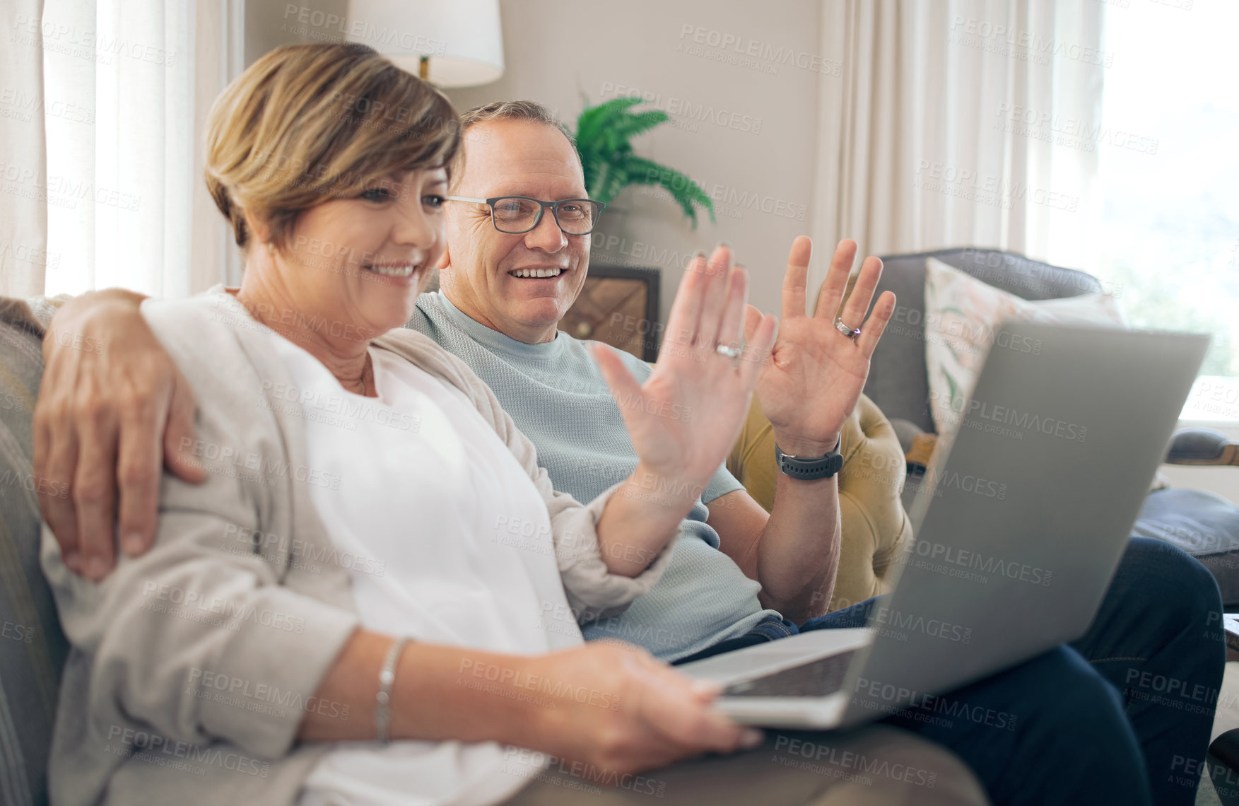 Buy stock photo Shot of a mature couple using their laptop to make a video call