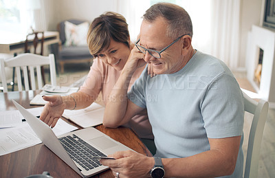 Buy stock photo Shot of a mature couple using their bank card to digitally pay their bills