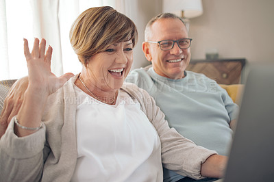 Buy stock photo Shot of a mature couple using their laptop to make a video call