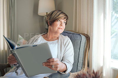 Buy stock photo Shot of a mature woman spending time relaxing and reading