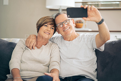Buy stock photo Shot of a mature couple taking selfies