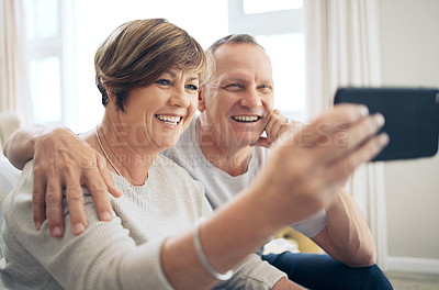 Buy stock photo Shot of a mature couple taking selfies