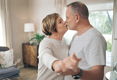 Buy stock photo Shot of a mature couple slow dancing in their lounge
