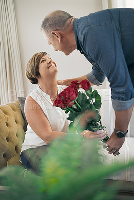 Buy stock photo Shot of a husband giving his wife roses