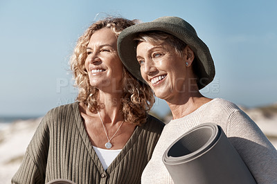 Buy stock photo Cropped shot of two attractive mature woman standing with their on the beach