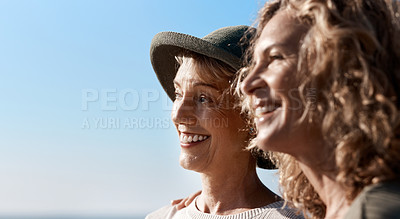 Buy stock photo Cropped shot of two attractive mature women standing on the beach