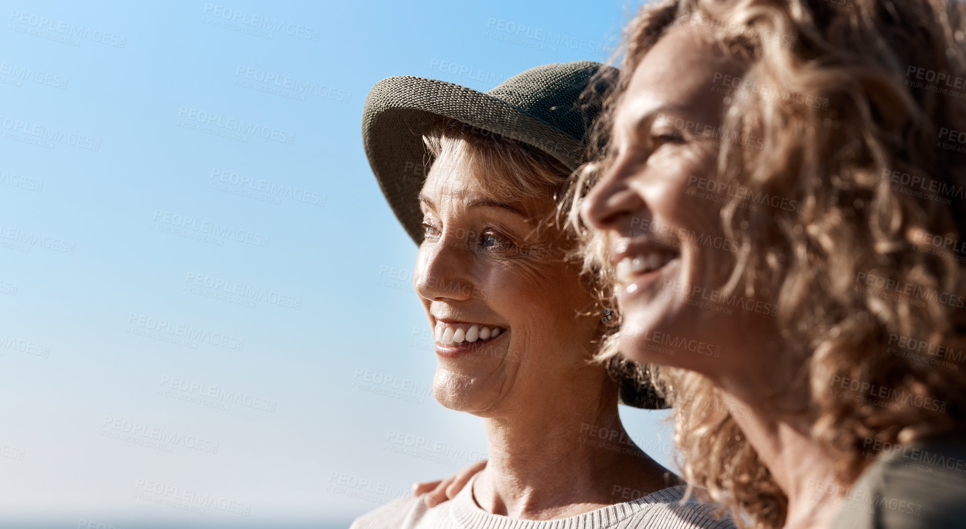 Buy stock photo Cropped shot of two attractive mature women standing on the beach