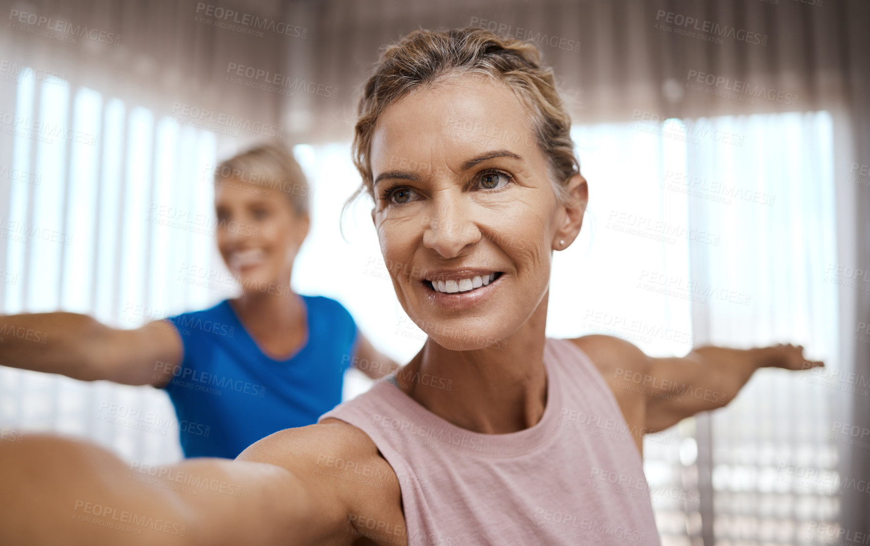 Buy stock photo Shot of two mature women exercising together at home