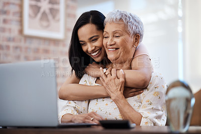 Buy stock photo Shot of a senior woman using a laptop with her daughter at home
