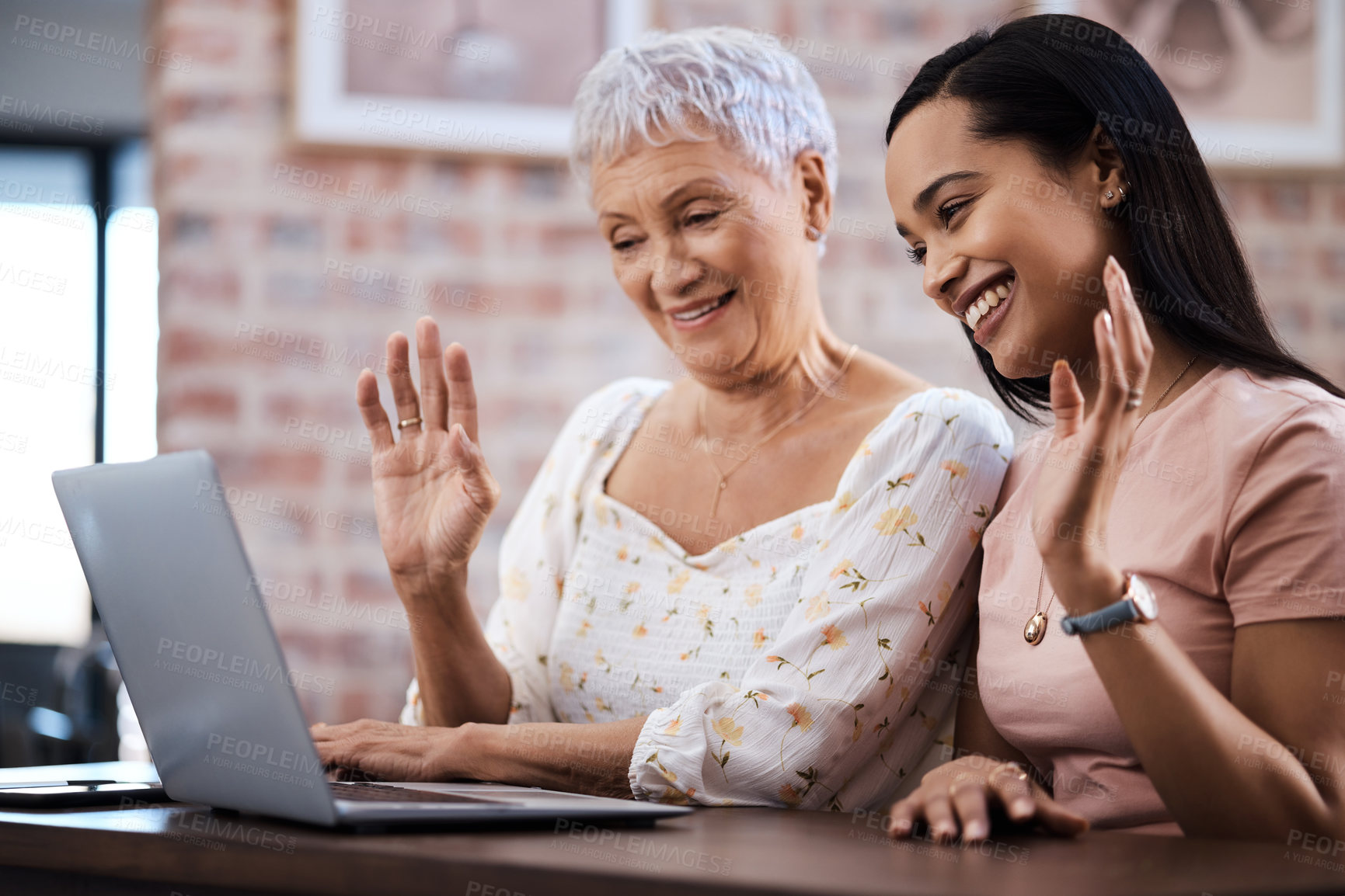 Buy stock photo Shot of a senior woman using a laptop with her daughter to make a video call at home