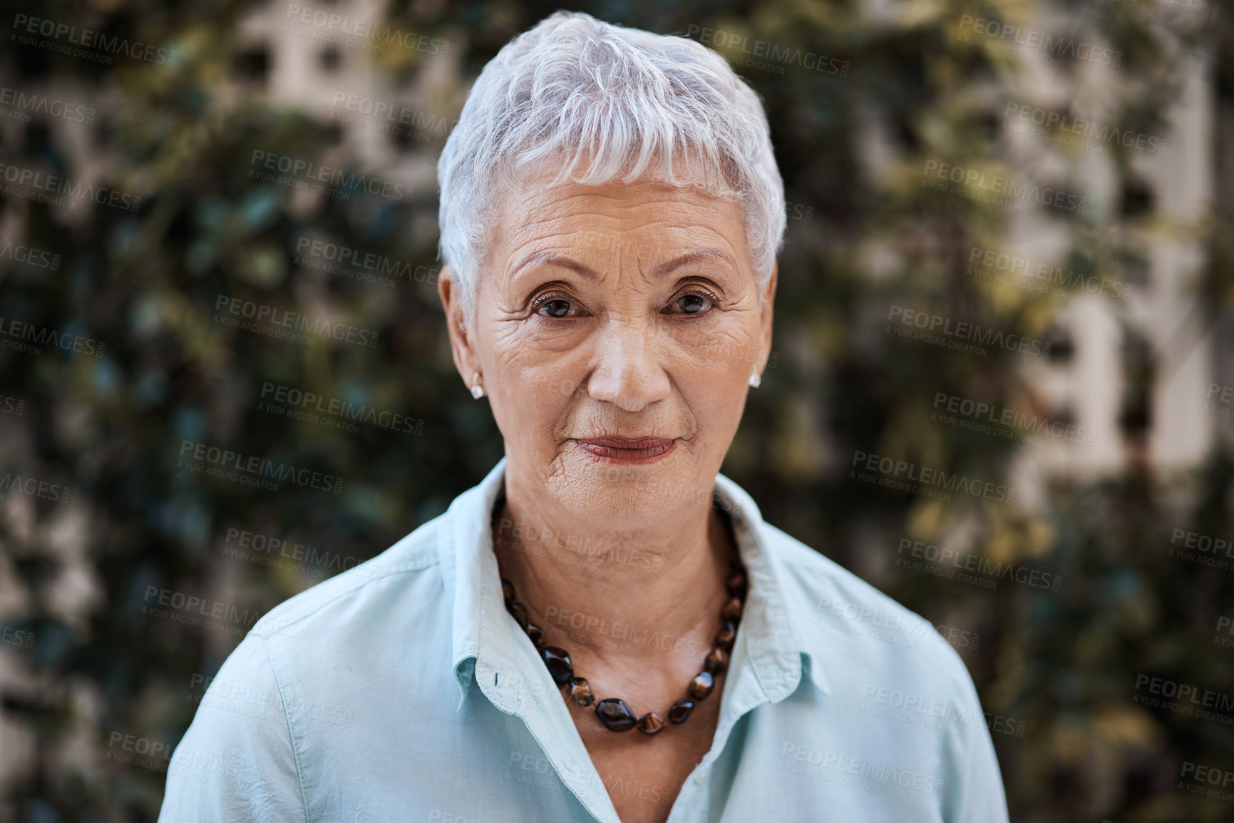 Buy stock photo Shot of a senior woman in the garden at home