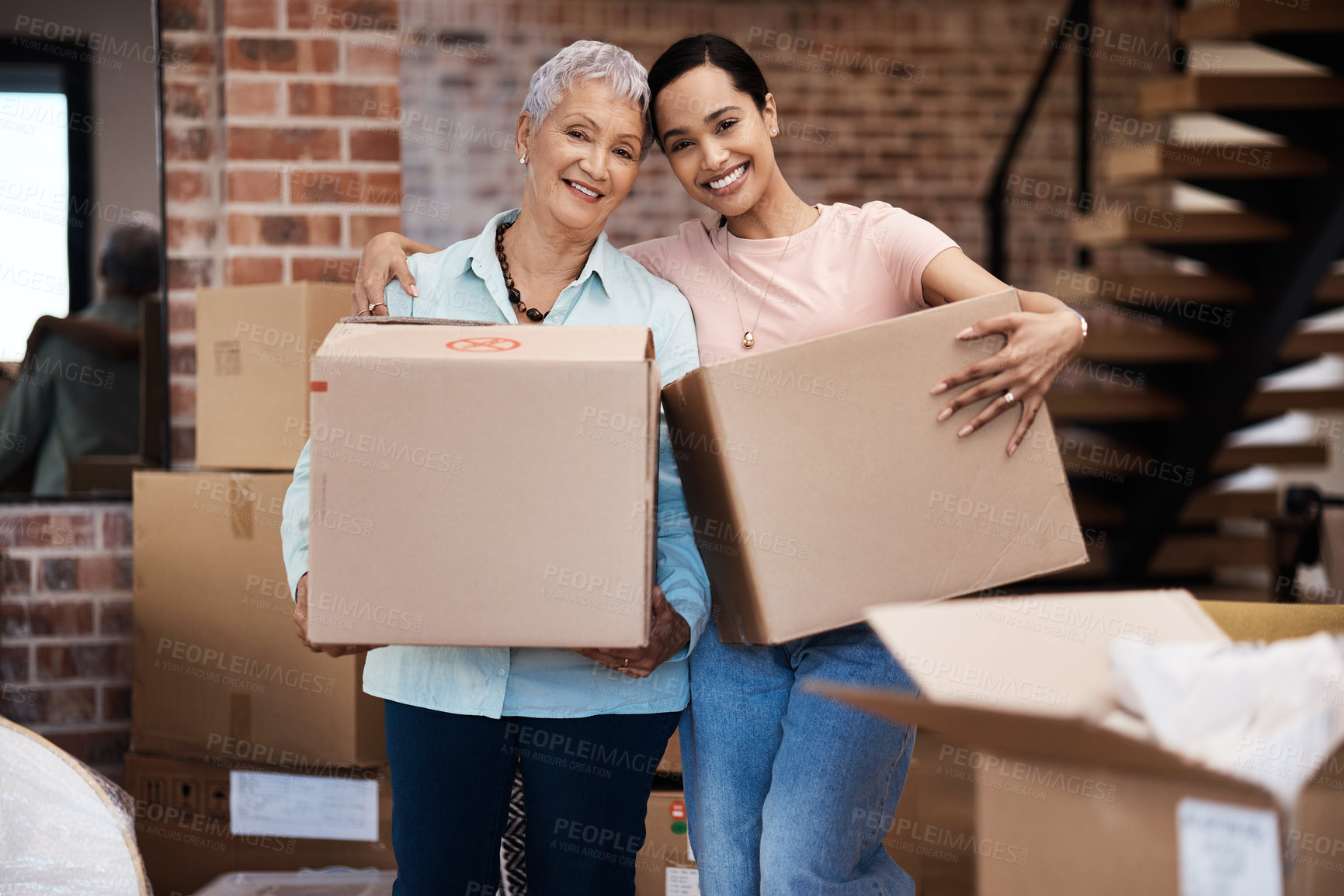 Buy stock photo Shot of a senior woman moving house with help from her daughter