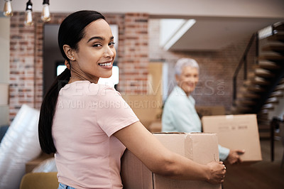 Buy stock photo Shot of a young woman helping her elderly mother move house