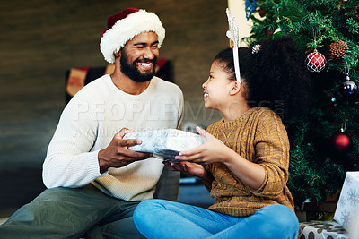 Buy stock photo Christmas, gift and happy black family with child excited to guess what is inside surprise box. Love, happiness and dad giving daughter present at festive holiday tree with smile of excitement.

