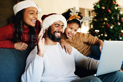 Buy stock photo Christmas, video call and laptop with family in living room for communication, connectivity and celebration. Internet, technology and online with parents and child wave for holiday, festive and xmas