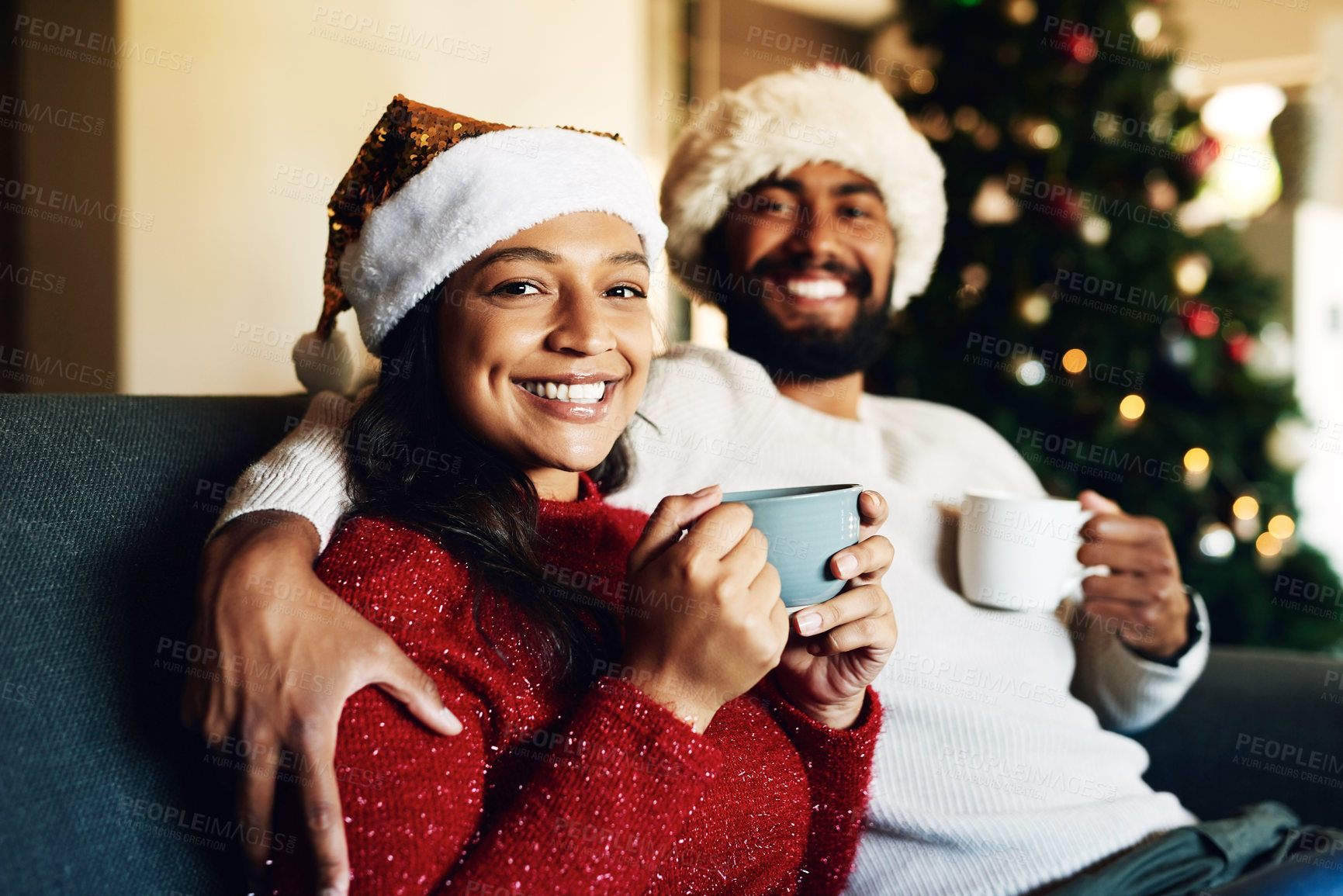 Buy stock photo Christmas, portrait and coffee with a black couple on a sofa in the living room of a home to relax together. Happy, smile and love with a man and woman bonding in celebration of the festive season