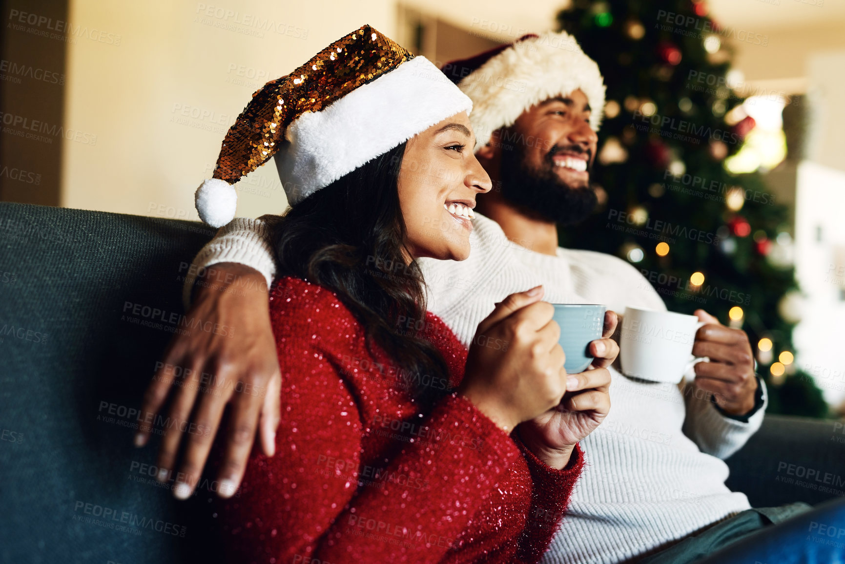 Buy stock photo Christmas, black couple and coffee or tea on sofa in living room while thinking about holiday celebration, shopping and home memory. Man and woman on couch with love, care and excited to celebrate