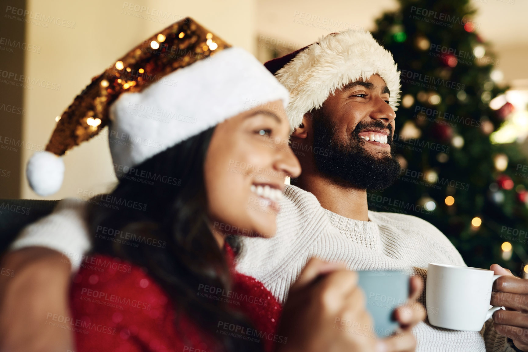 Buy stock photo Christmas, couple on couch and hot chocolate with smile or happiness to relax, festive season and at home together in living room. Xmas, love and man with woman, eggnog or loving together for bonding