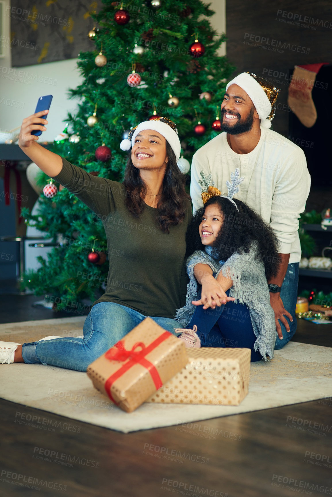 Buy stock photo Christmas, selfie and family with a mother, father and daughter taking a photograph by a tree in the living room. Children, floor and gift with a girl, man and woman posing for a holiday picture