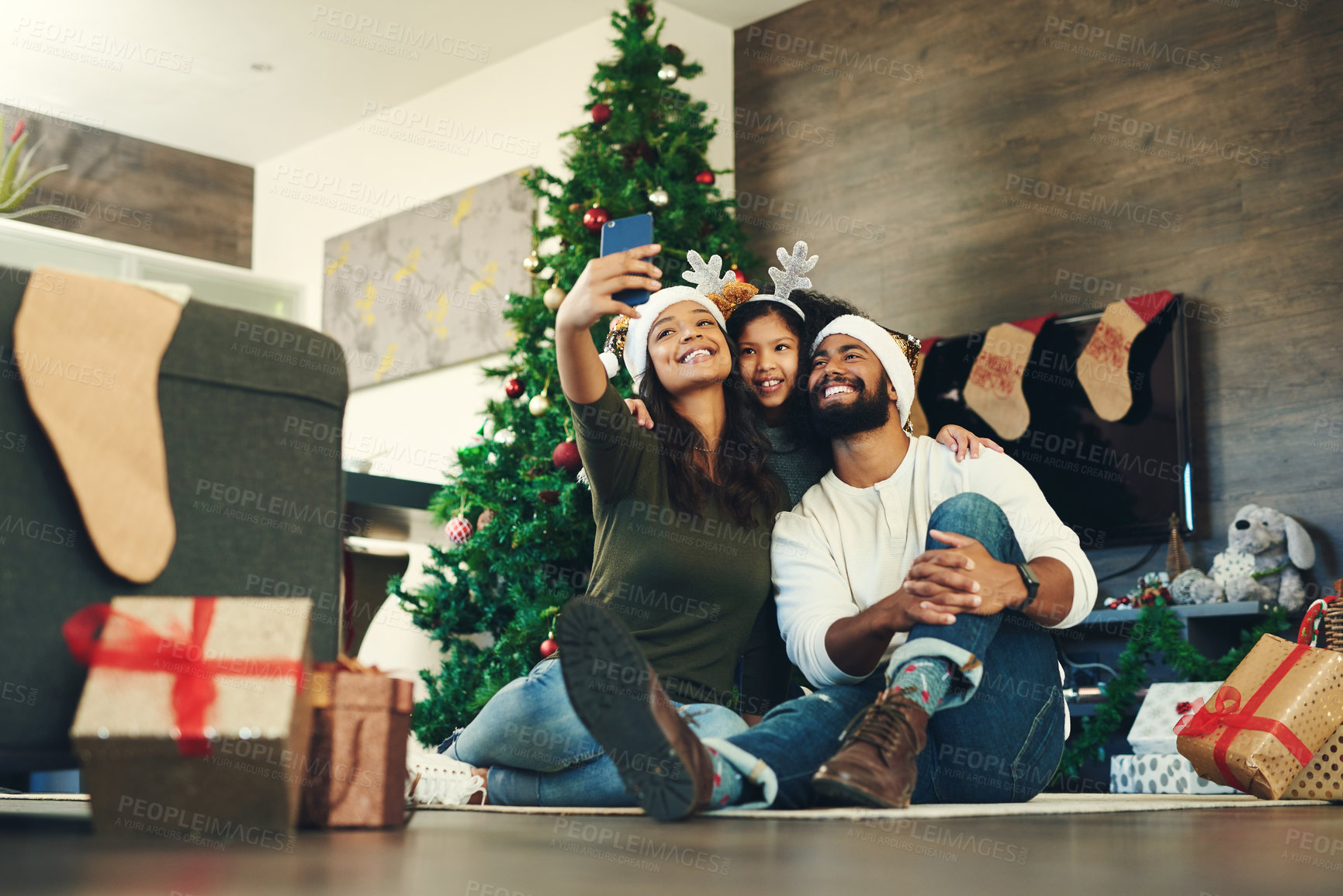Buy stock photo Family, selfie and celebrating christmas with a man, woman and child excited in a family photo for the festive season. Xmas, gift and mobile picture for social media with parents and kids 